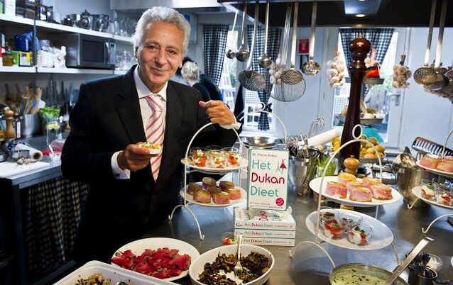 Pierre Dukan surrounded by dietary dishes